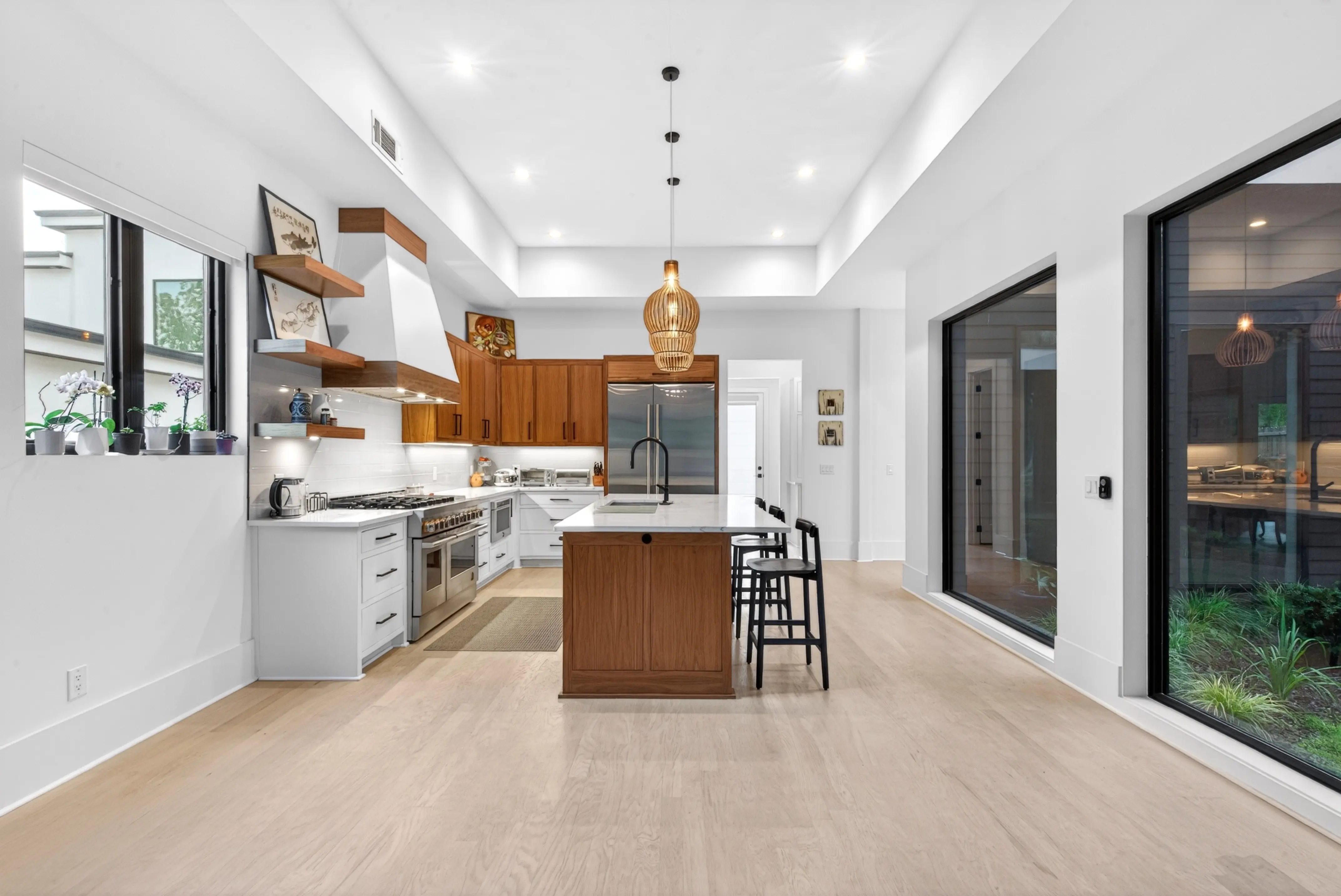 Bright modern kitchen with a wood island and large black-framed windows
