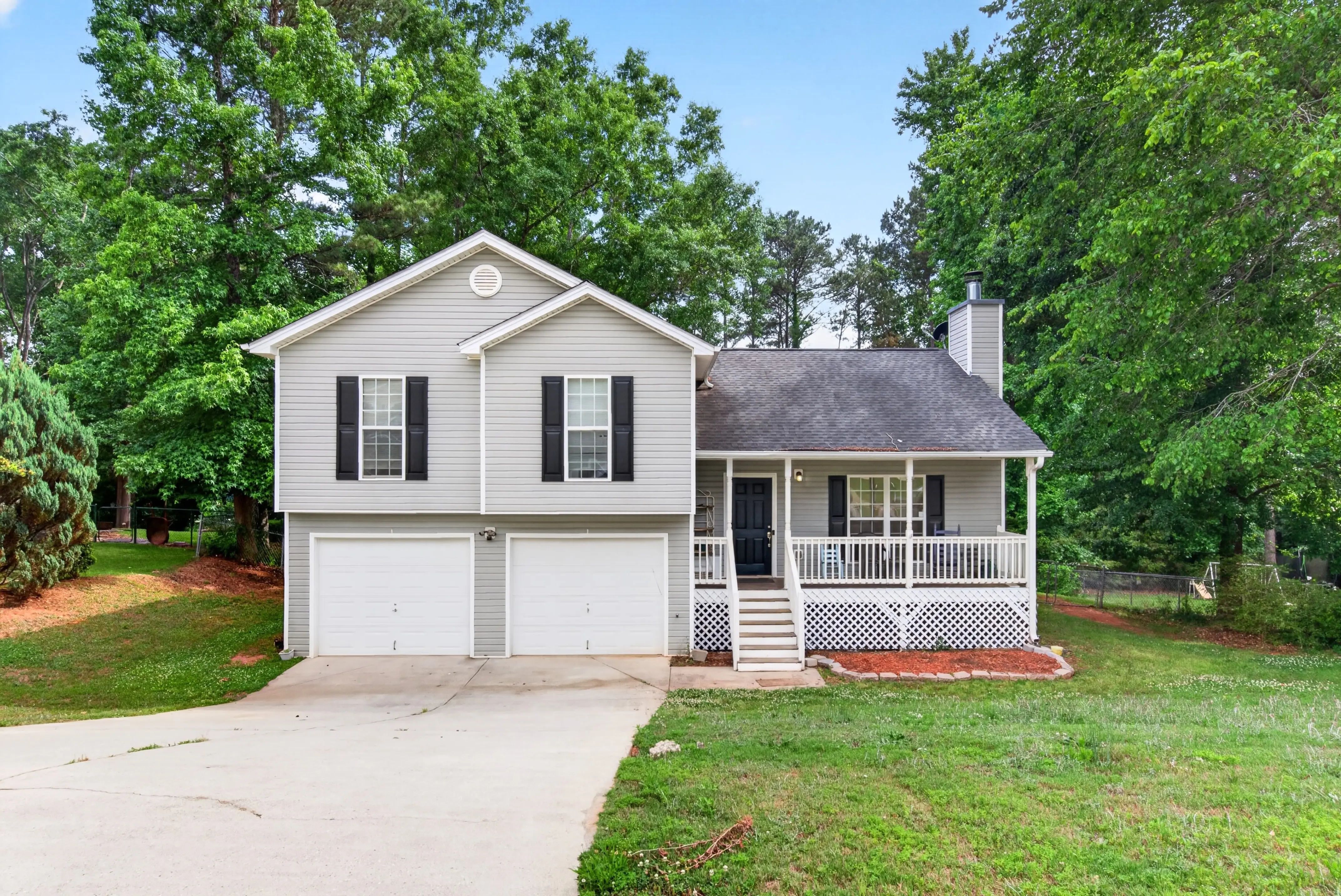 Split-level home with a double garage and covered porch