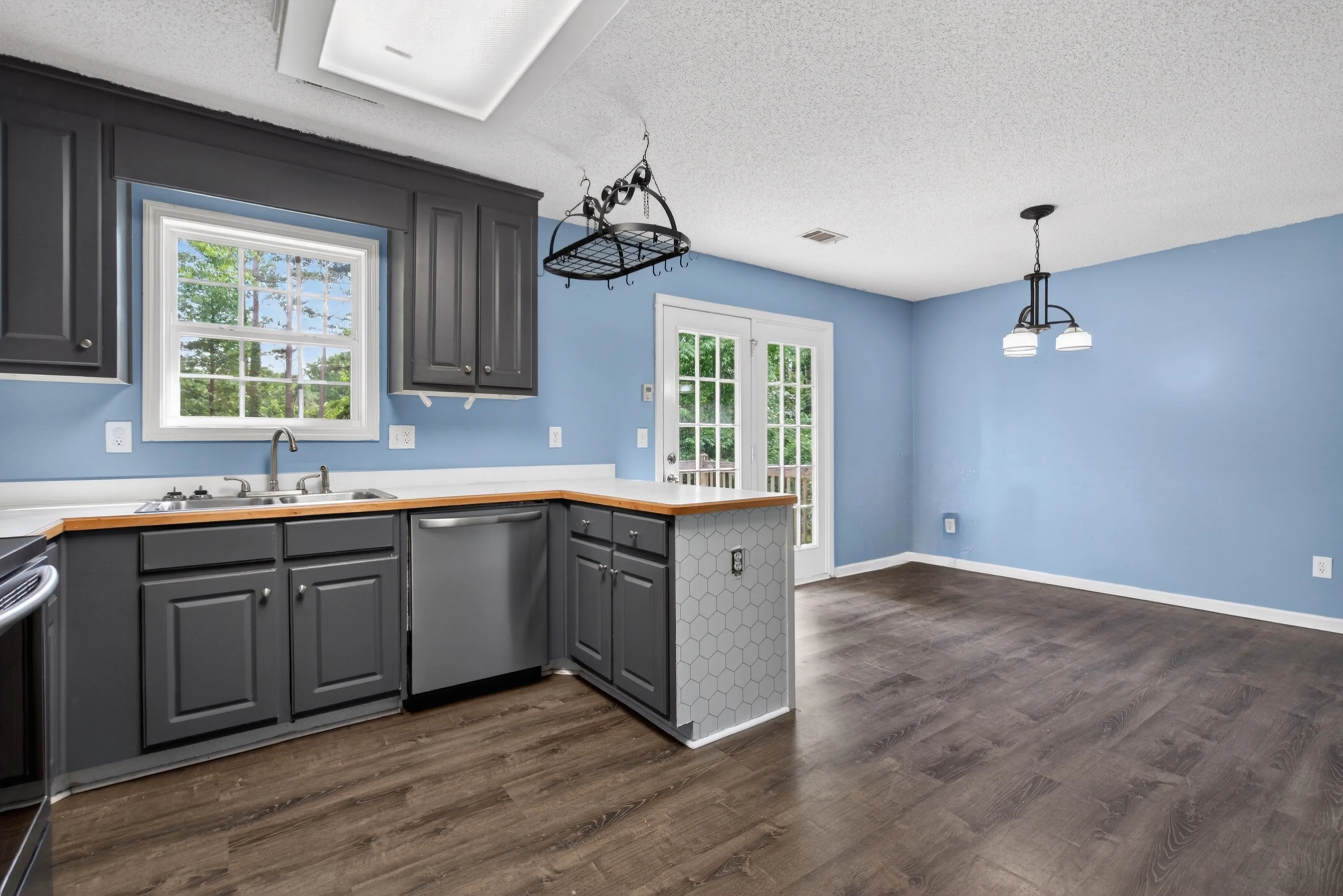 Kitchen and dining area with dark cabinets and French doors