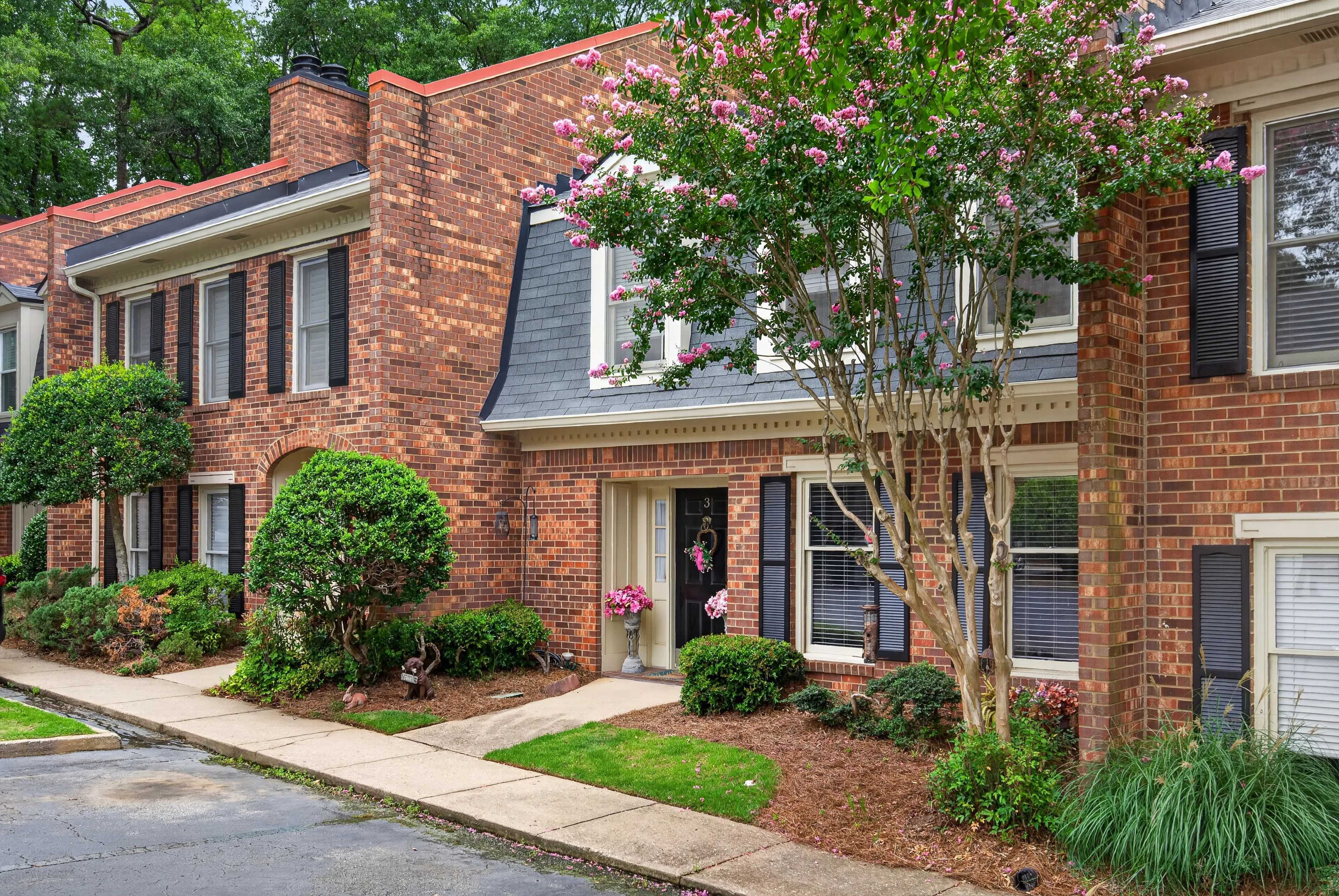Brick townhomes with flowering crepe myrtles