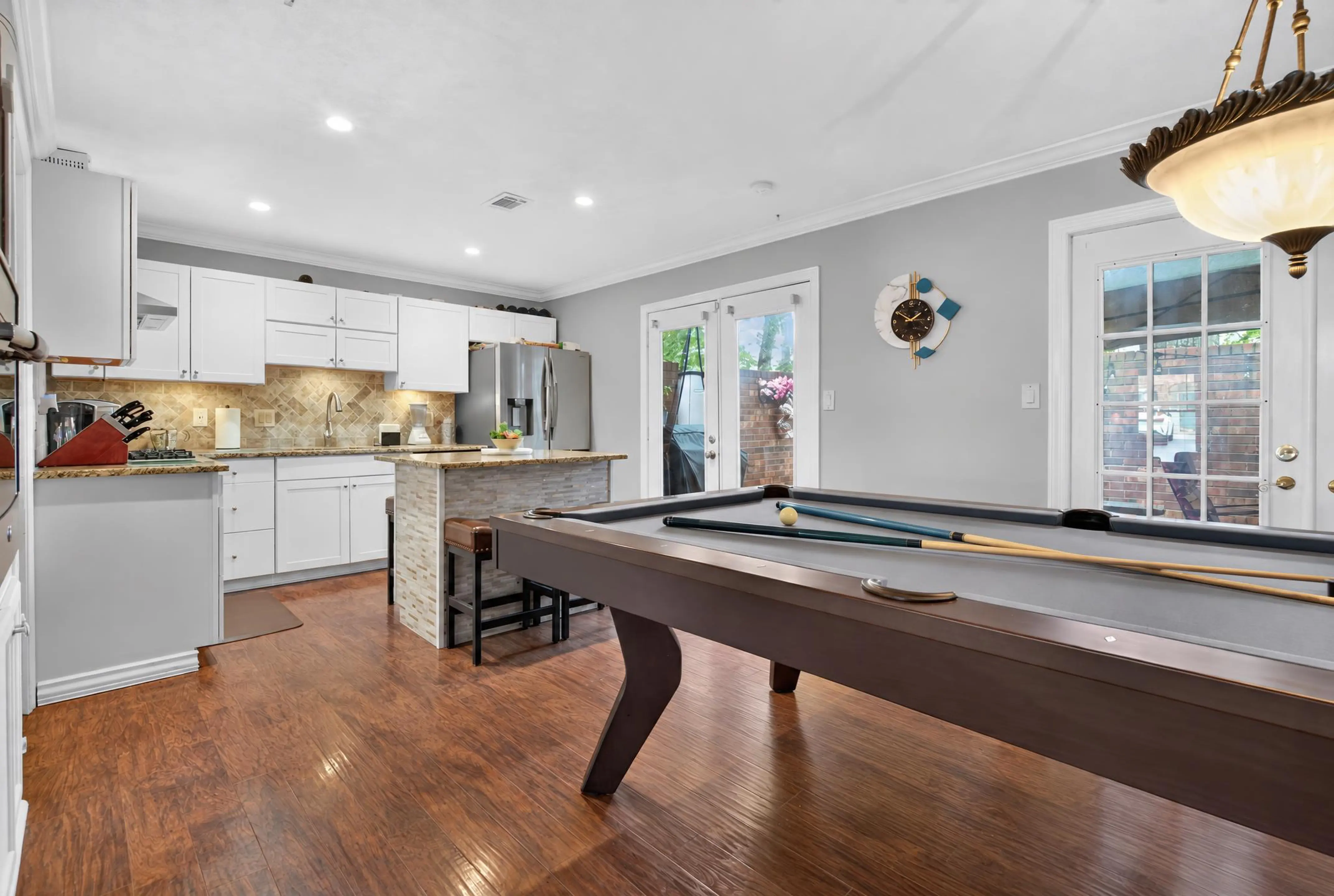 Kitchen and game room with a full-size pool table